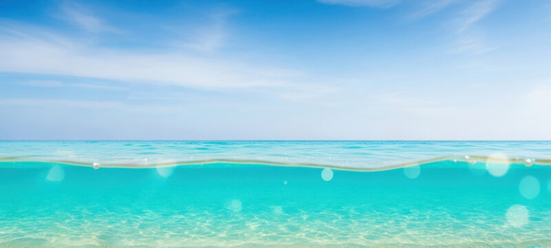 A serene beach scene with clear blue water and a blue sky. - Powered by Adobe