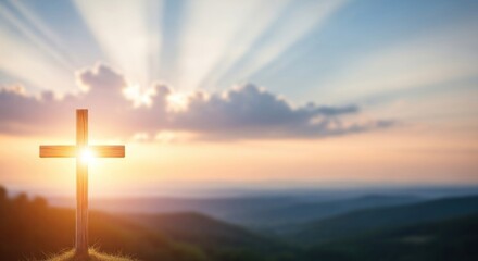 A wooden cross stands on a hilltop, with a sunset in the background.