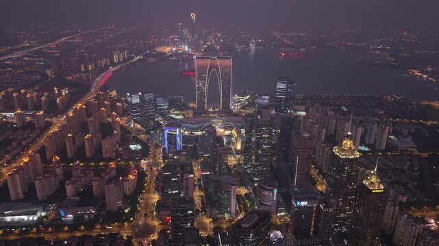 Aerial night view timelapse of the panoramic skyline of Jinji Lake and Gate of the Orient, Suzhou, Jiangsu Province, China