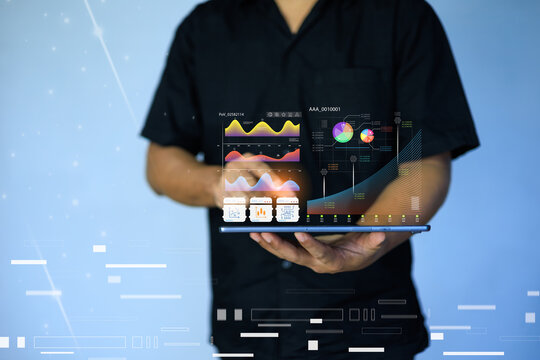 A businessman interacts with a futuristic digital interface,showcasing the application of artificial intelligence (AI) in modern workplaces.This conceptual image represents innovation,data analytics. - Powered by Adobe