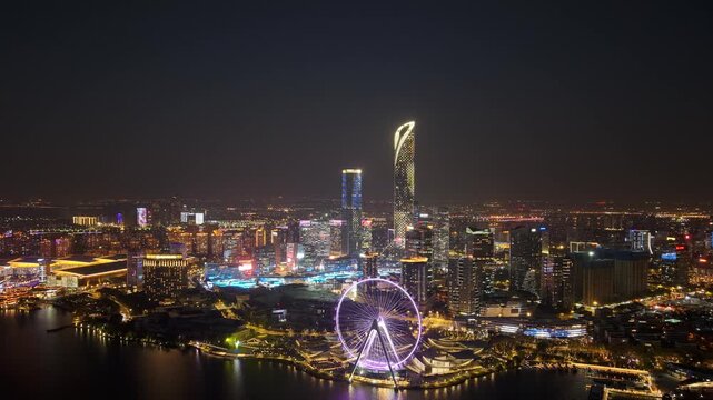 Aerial timelapse of Golden Rooster Lake and ferris wheel city skyline night view of Suzhou, Jiangsu Province, China