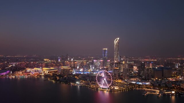 Aerial timelapse of Golden Rooster Lake and ferris wheel city skyline night view of Suzhou, Jiangsu Province, China