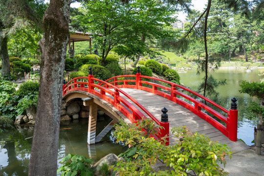 Red bridge in Shukkei-en Japanese garden in Hiroshima, Japan