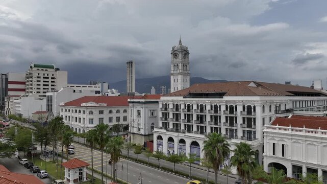 cloudy day penang island george town abandoned hotel front traffic bay street aerial panorama 4k malaysia