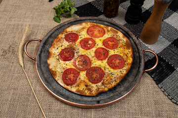 Neapolitan Brazilian pizza with mozzarella cheese and tomato slices with oregano