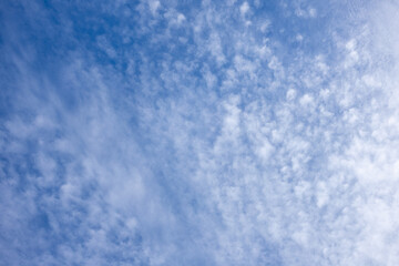 Light clouds scattered across blue sky.