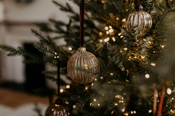 Golden Christmas Ornament on Tree with Warm Lights