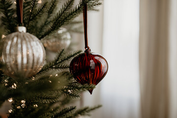 Red Glass Heart-Shaped Christmas Ornament on Tree