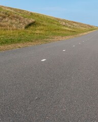 long cycle path along the dike on the dutch north sea