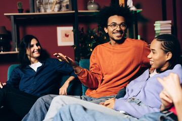 Diverse young friends socializing and laughing, enjoying a casual party together