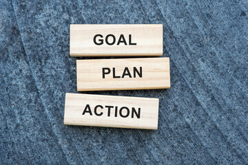 Goal, Plan, Action blocks on texture. Concept for setting business goals, strategic planning, and taking immediate action. Motivation.