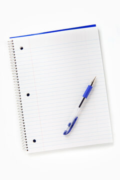 Wirebound notebook and pen on white background