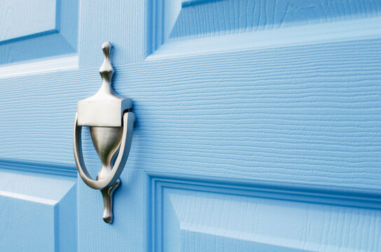 Close-up of door knocker on blue front door
