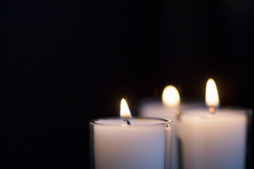 Close-up of votive candles on black background