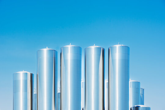 Steel dairy silos against clear sky