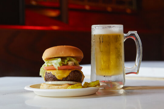 Cheeseburger and beer on restaurant table