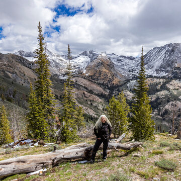 Portrait of female hiker with snowcapped Pioneer Mountains in background