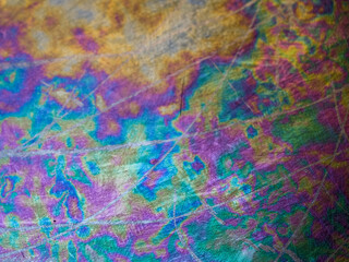 Close-up view of scratched and oxidized stainless steel pan