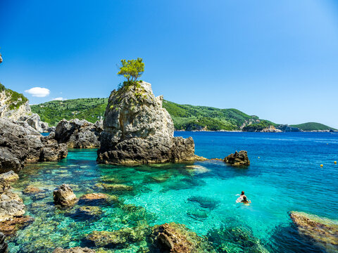 Two people swimming in crystal clear waters of all Grotta bay