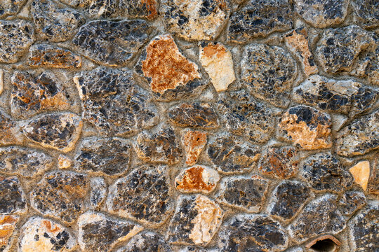 Close-up of gray and brown cobblestone wall