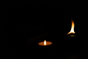 burning candle on black background