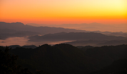 A mountain range with a beautiful orange sky Doi maesalong, Chiang rai,thailand