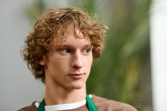 Creative young man engaged in deep thought while enjoying a peaceful moment indoors - Powered by Adobe