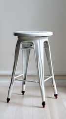 White metal stool with a sleek design, illuminated softly, positioned against a neutral background