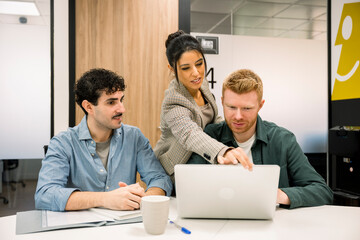 Colleagues collaborating on new project in modern office