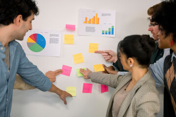 Diverse team brainstorming new ideas using sticky notes