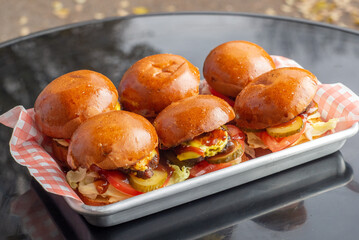Set of small burgers with meat cutlet and vegetables and french fries