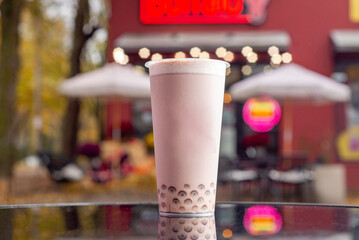 Bubble tea in a tall glass with a straw to go
