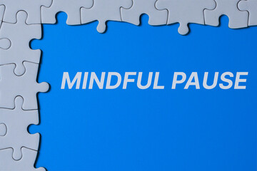 White puzzle pieces surrounding a bright blue center with the text “Mindful Pause,” symbolizing self care concept, mental reset, and taking short breaks to improve focus and well-being.