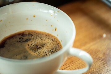 Espresso Tools: Professional Portafilter and Glass Cup with Rich Crema on Rustic Wooden Table Espresso Perfection: Dark Roast Coffee with Crema, Portafilter, and Chrome Machine Parts on Wood