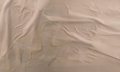 Folded white paper texture backdrop, crumpled poster surface, empty background for text or graphics