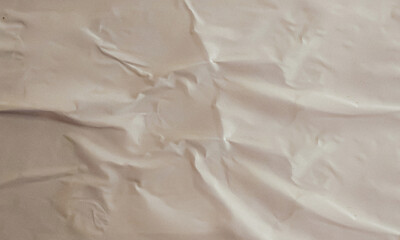 Folded white paper texture backdrop, crumpled poster surface, empty background for text or graphics