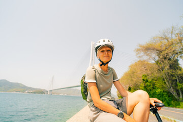shikoku, japan - 3 august 2025 Female cyclist on Shimanami kaido cycling route
