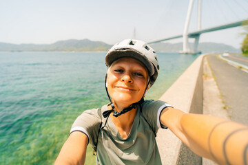 shikoku, japan - 3 august 2025 Female cyclist on Shimanami kaido cycling route
