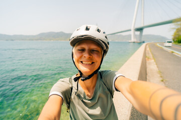 shikoku, japan - 3 august 2025 Female cyclist on Shimanami kaido cycling route