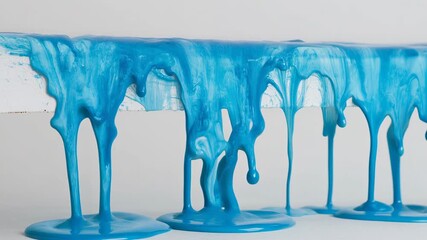 Vibrant blue paint dripping artfully from a white surface, perfect for creative projects. - Powered by Adobe