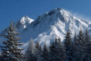 Obraz premium Peaceful winter mountain landscape with snow-capped peaks.