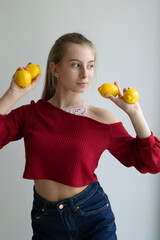 girl holding fresh lemons on light background healthy eating concept