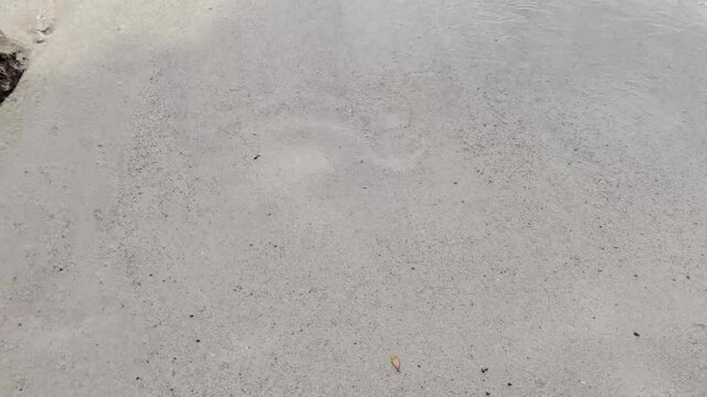 Draw a heart on the wet sand with footprints on the left side of the heart. The heart and footprints were washed away by the waves. Unrequited love. Lost love.
