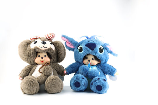 a popular classic doll toy , Monchichi or Monchhichi , Japanese cute monkey fur doll display on white table with white wall background in souvenir tourist shop in Japan