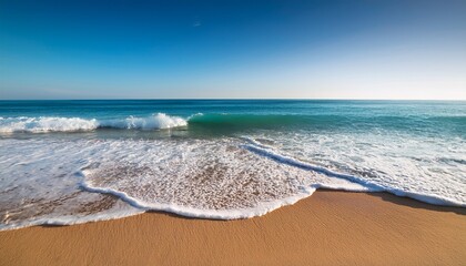 seaside scene with waves clear sky and sandy shore in summer