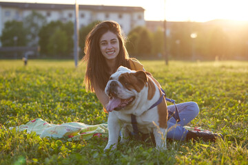 Young brunette girl play with her british bulldog