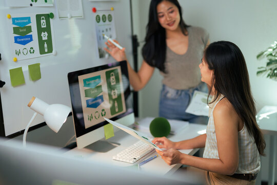 Women collaborating on ESG strategy in office - Powered by Adobe