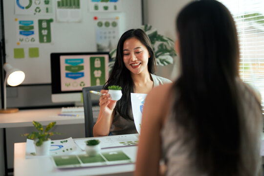Asian woman presenting sustainable business ideas in office