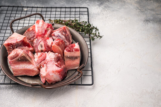 Raw Beef meat and veal bones for stew or goulash. grey background. top view