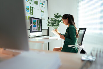Businesswoman planning sustainable strategy at modern office